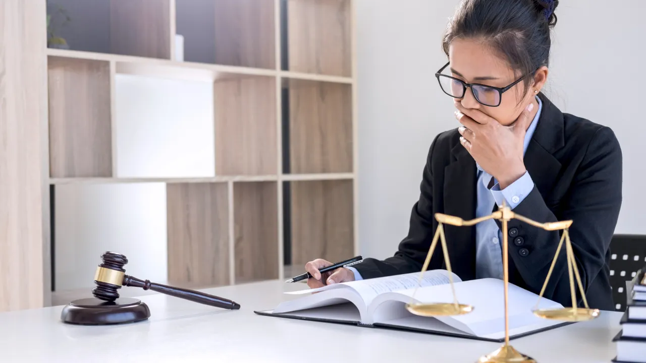 Professional law office with attorneys reviewing documents and case files